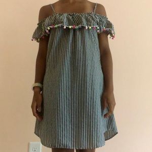 off-the-shoulder grey ruffled dress with pom poms